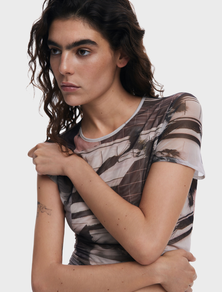A T-shirt adorned with an eye-catching art print, combining creativity and fashion for a modern wardrobe staple.
