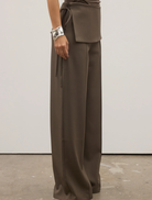 A model showcases a brown top and wide-legged Vela Pant in Ash.