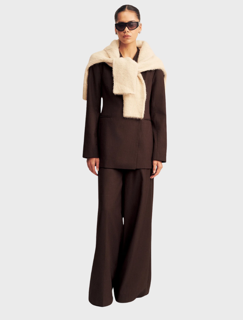 A double-breasted blazer in Ristretto color, featuring a tailored fit and classic lapels for a sophisticated look.