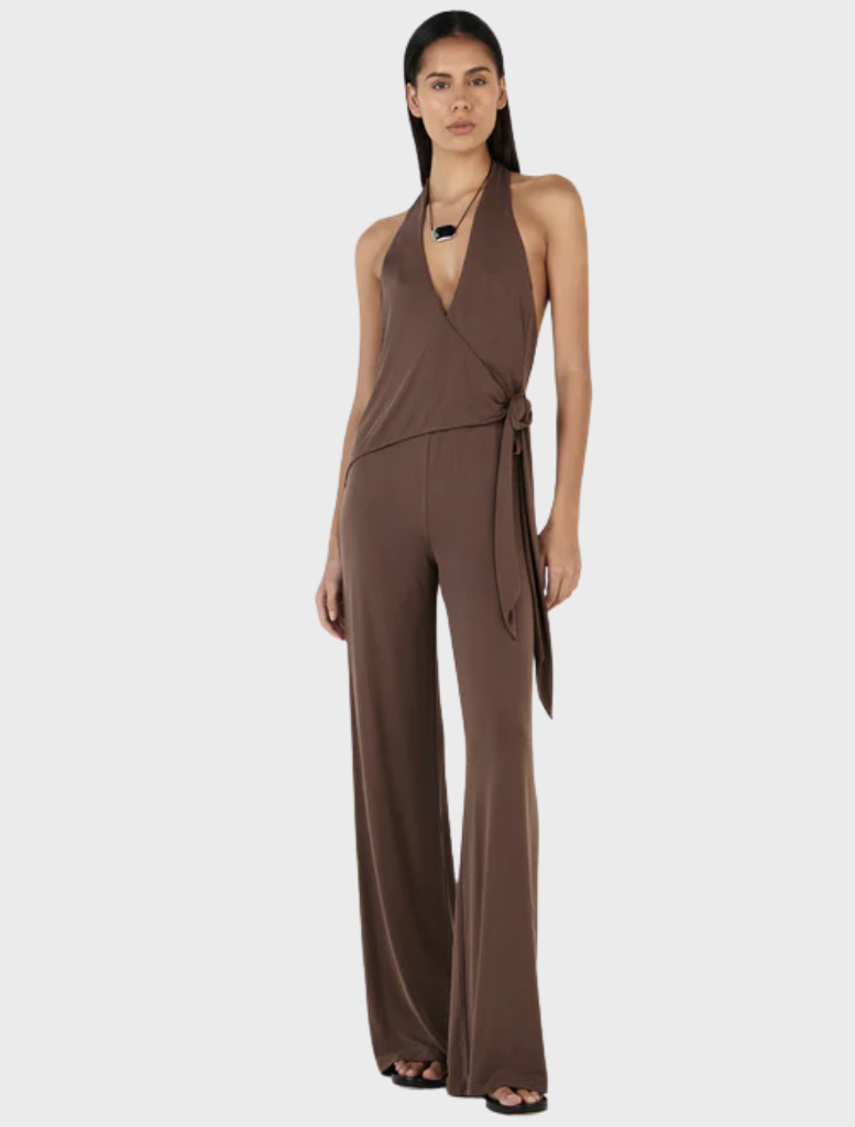 Chocolate Astrid jumpsuit laid flat, highlighting its stylish cut and fabric texture.