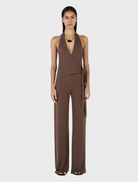 Chocolate-colored Astrid jumpsuit displayed on a mannequin, featuring a fitted bodice and wide-leg pants.