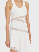 Fitted Echo Asymmetric Tank Dress with draped hem and sheer lace paneling, featuring fine lace trim along the hemline.
