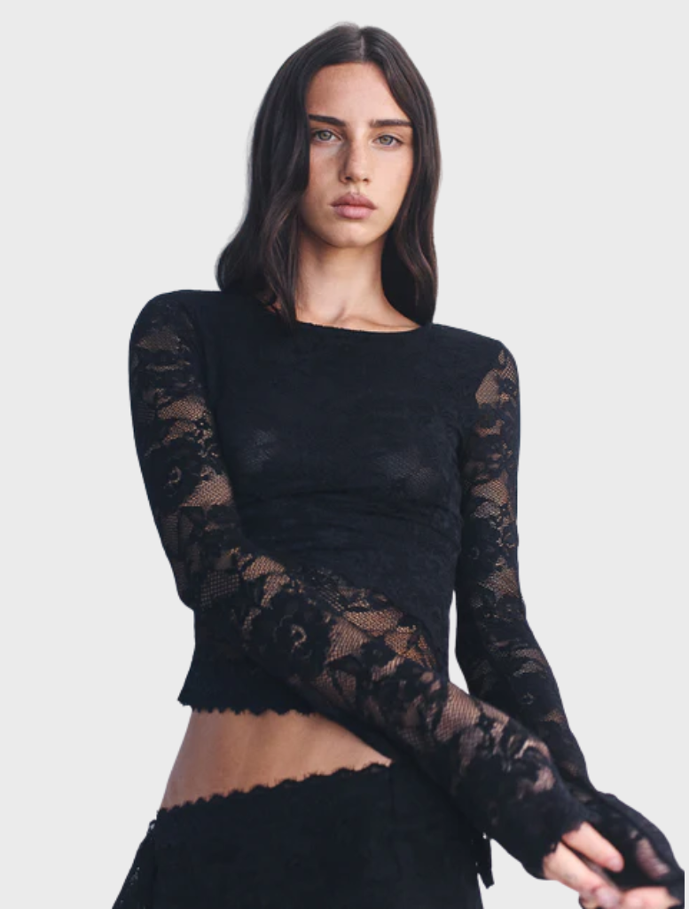 Black Avery top displayed on a hanger, featuring a sleek design and soft fabric, suitable for casual or formal wear.