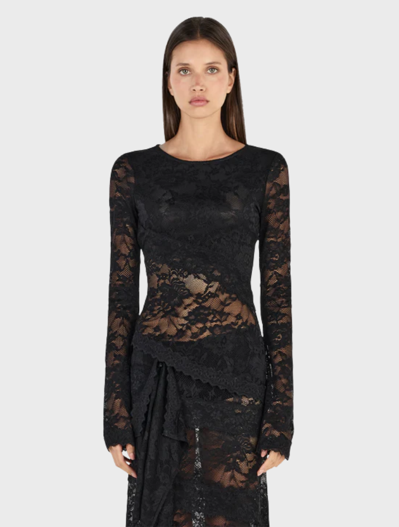 Black Avery top displayed on a hanger, featuring a sleek design and soft fabric, suitable for casual or formal wear.