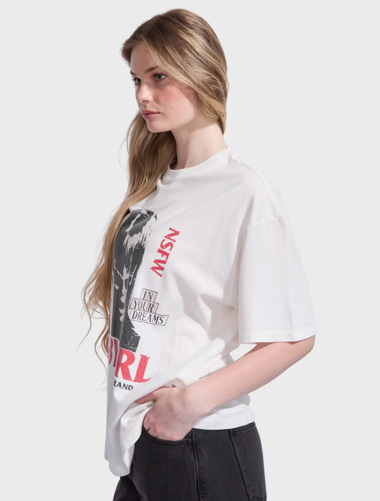 White sand Babygirl Tom Tee featuring a relaxed fit and playful design, perfect for casual wear.