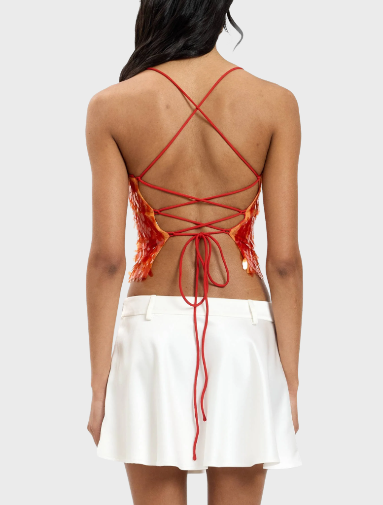 Shimmering burnt orange backless top embellished with sequins, ideal for special occasions.