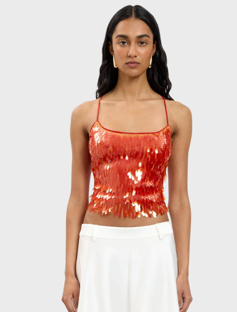 Backless burnt orange top adorned with sequins, showcasing a stylish and shimmering design.