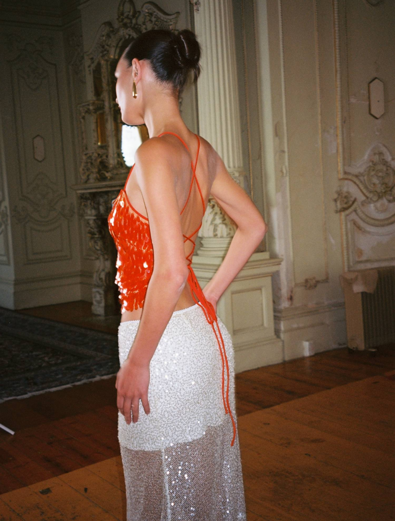 Stylish burnt orange backless top with a sequin finish, designed for a fashionable and festive outfit.
