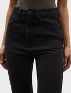 Tilly Bootleg Jean featured backstage, emphasizing its trendy silhouette and material in a vibrant fashion show environment.