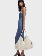 A white bag in a new shape, designed for stylish and functional use, showcasing a modern aesthetic.