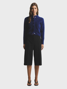 Navy Bella Cashmere Cardigan displayed on a hanger, showcasing its soft texture and elegant design