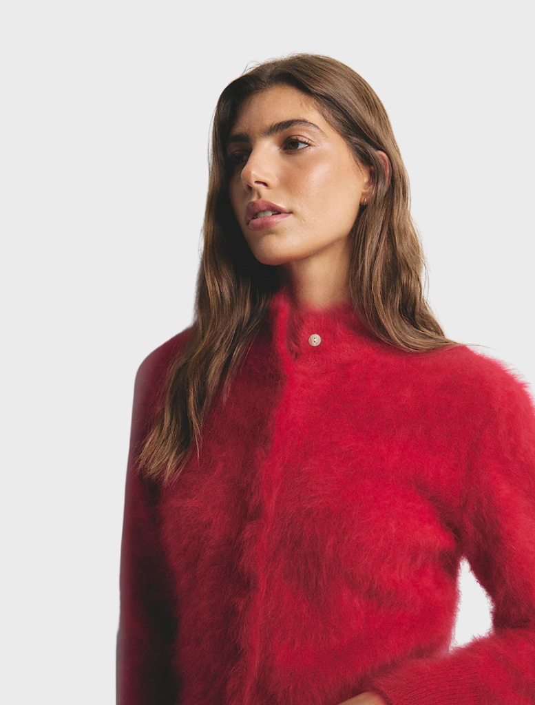 Bella Cashmere Cardigan in flame hue, highlighting its soft cashmere fabric and refined style for any occasion.