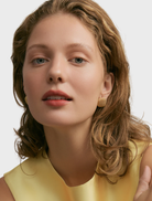 Stylish gold Bernadine earrings showcasing a refined design, suitable for enhancing any ensemble.