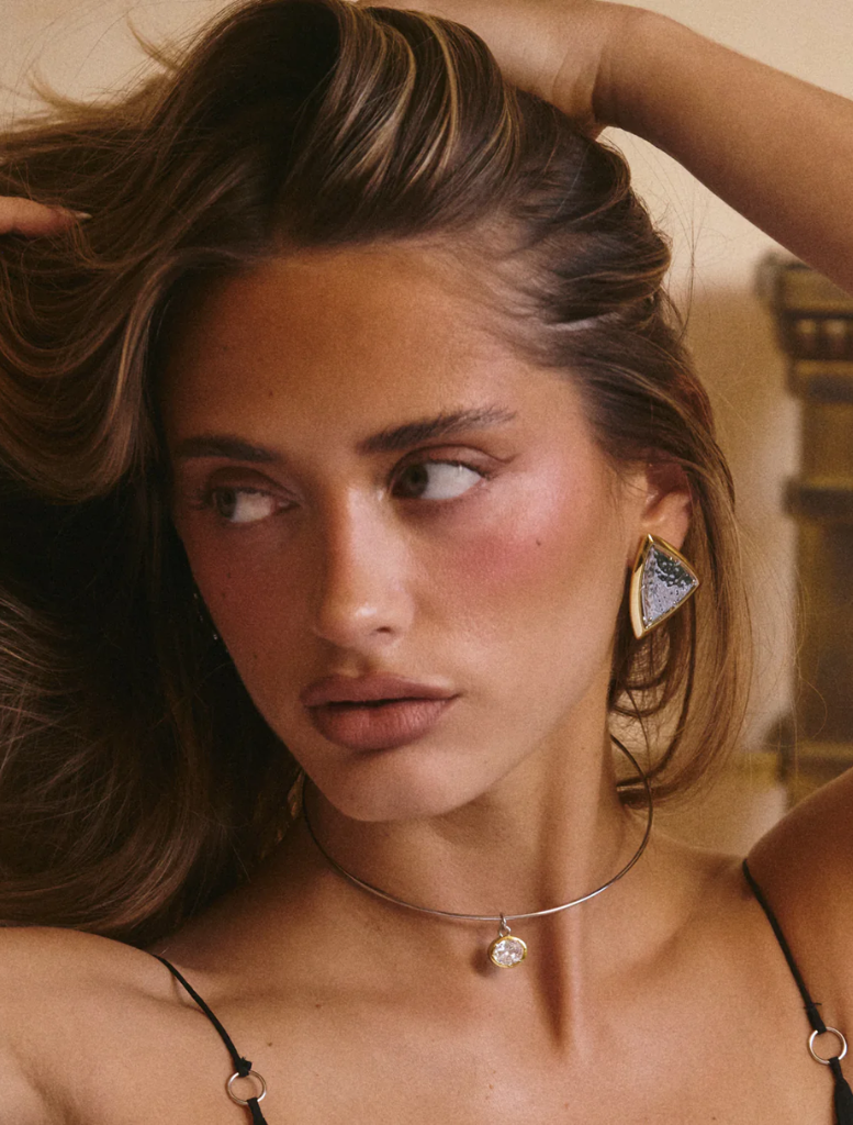 Two-tone gold and silver triangle stud earrings, named Bianco Nero Studs - Gold, elegantly designed for a modern look.