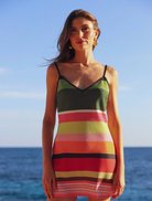 Emerald striped mini dress with a bias cut, featuring a flattering silhouette and stylish design for casual or formal wear.