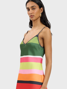 Stylish mini dress in emerald stripes, designed with a bias cut for a flattering fit, suitable for both casual and dressy events.