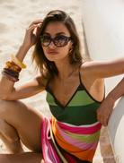 Elegant mini dress in emerald stripes, designed with a fitted shape and short sleeves for a chic, modern look.