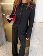 Front view of a black Alba Jacket, highlighting its modern cut and stylish appearance.