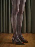 A pair of black delicate tights laid flat, highlighting their lightweight fabric and elegant design.