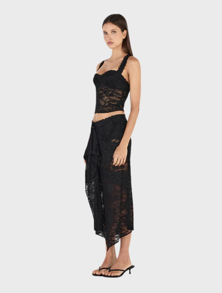 Stylish black Gigi wrap skirt on a model, emphasizing its flattering silhouette and comfortable wrap-around style.