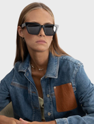 Hailey II sunglasses showcasing a black design with grey lenses, combining elegance and functionality.