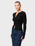 Black Lyon Cardigan showcased, highlighting its long sleeves and open front, perfect for stylish layering in any outfit.