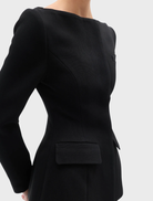 A black Laurent blazer hanging, featuring a modern cut and elegant style suitable for formal occasions.