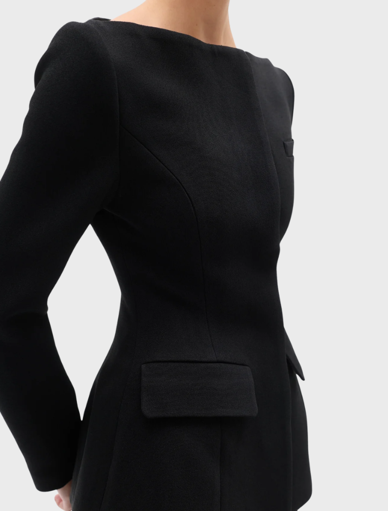 A black Laurent blazer hanging, featuring a modern cut and elegant style suitable for formal occasions.