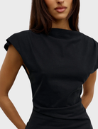 Elegant black Liana top hanging, highlighting its modern style and smooth material.