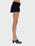 Passage's black mini shorts, tailored for a chic silhouette, suitable for various casual settings.