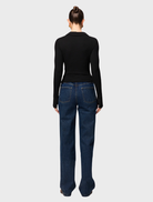 Elegant black polo top from Florence, designed for versatility and comfort, perfect for everyday wear.