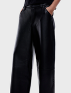 Elegant black leather pants with a tailored fit, perfect for both casual and formal occasions.