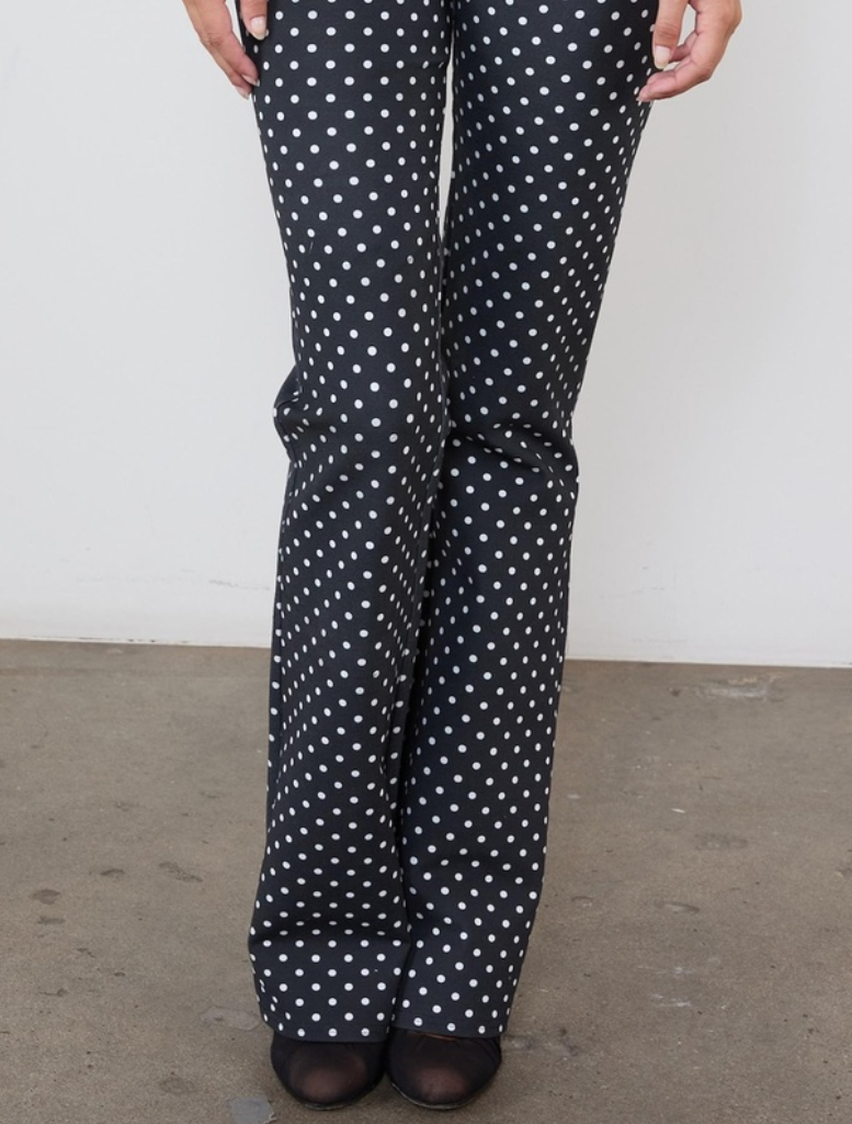 Stylish black trousers with a pattern of small white dots, ideal for both professional and casual wear.