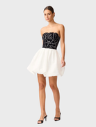 Stylish strapless mini dress in black and white, highlighting a form-fitting design perfect for various occasions.