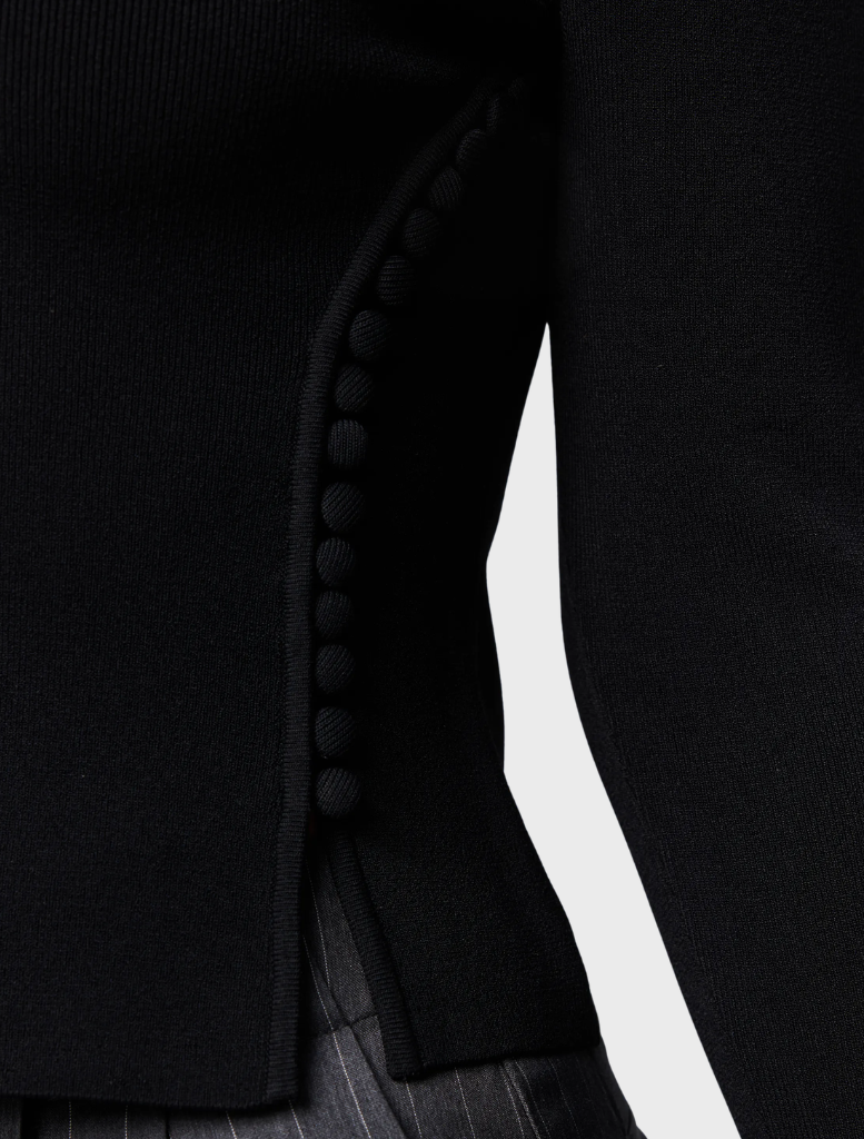 Elegant black Windsor knit top, perfect for layering or standalone wear in various settings.