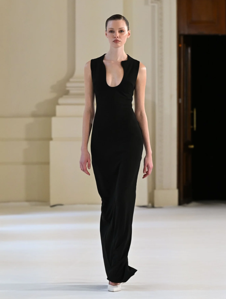 Elegant black Bloom gown featuring a flowing silhouette and delicate detailing, perfect for formal occasions.