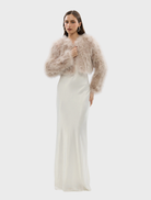 A blush-colored Manhattan crop jacket showcased, highlighting its contemporary style and tailored fit.