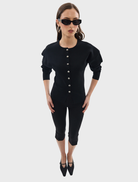 Black Bronte knit cardigan hanging against a neutral background, illustrating its versatile and chic appearance.
