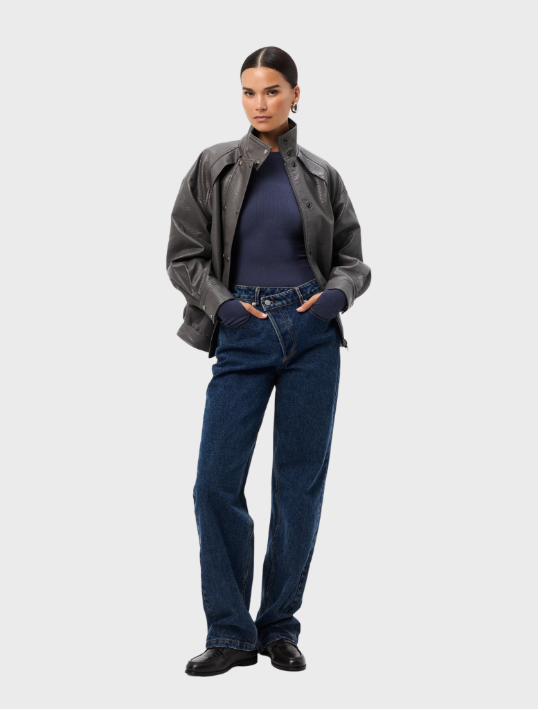The Brooklyn Top in a rich sapphire hue, featuring a modern silhouette and lightweight fabric, presented on a hanger.