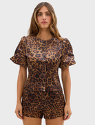 Leopard print poppy blouse with bubble sleeves, combining elegance and modern fashion for a standout outfit.