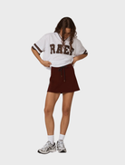 Burgundy Palmer mini skirt shown flat, illustrating its chic design and soft material suitable for various occasions.