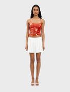 Burnt orange sequin top featuring a backless design, perfect for a glamorous evening look.