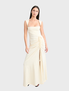 Samara gown in a warm butter hue, designed with a flattering fit and flowing fabric for a refined look.