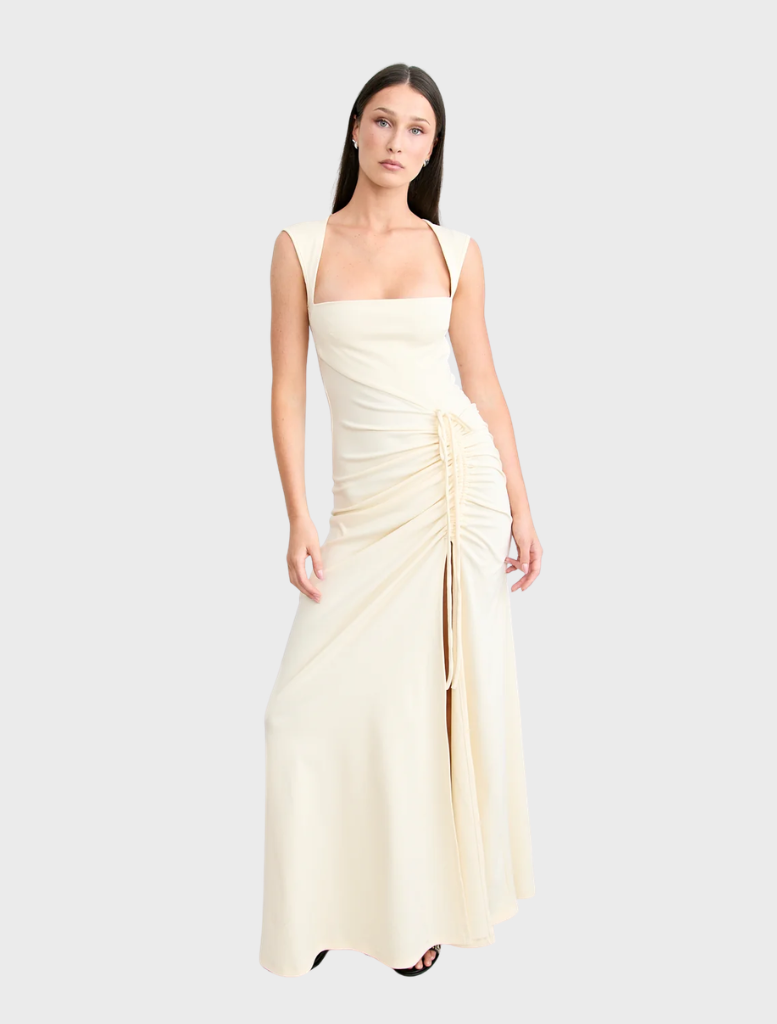 Samara gown in a warm butter hue, designed with a flattering fit and flowing fabric for a refined look.