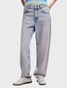 A pair of medium wash Cara jeans on a neutral backdrop, featuring a traditional cut and subtle fading for a casual look.