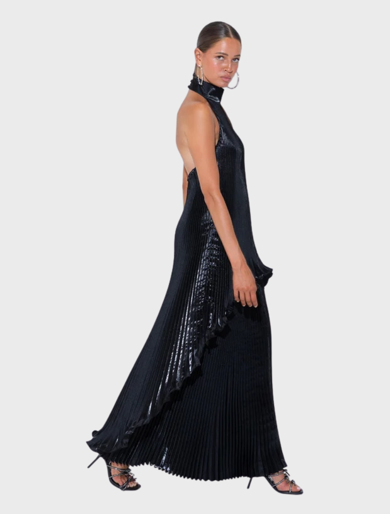 Glossy Caribbean Mini dress showcases a high halter neck, pleated design, and a flowing back panel with a scalloped hem.