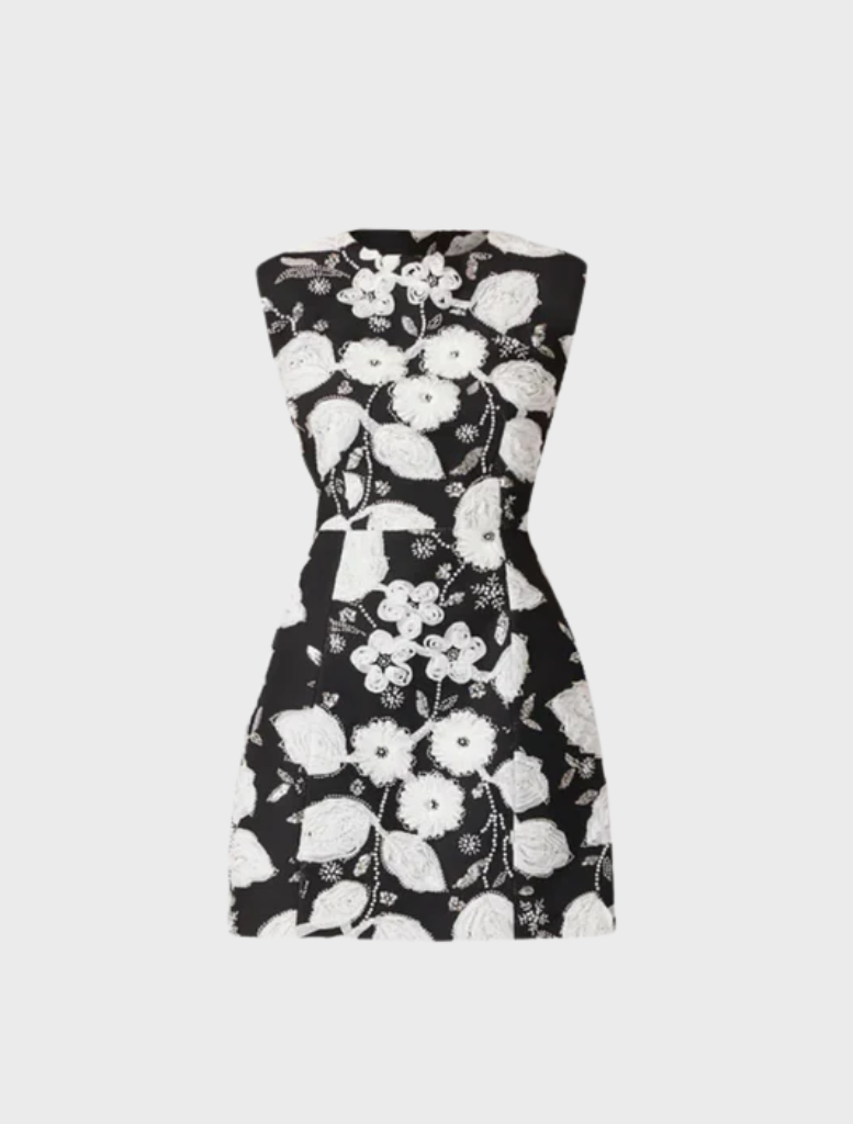 Chic black and white Carol Tulip mini dress showcasing a floral print and a flared design, suitable for various events.