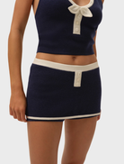 Navy Caroline Top presented on a hanger, highlighting its refined design and comfortable fabric for everyday use.