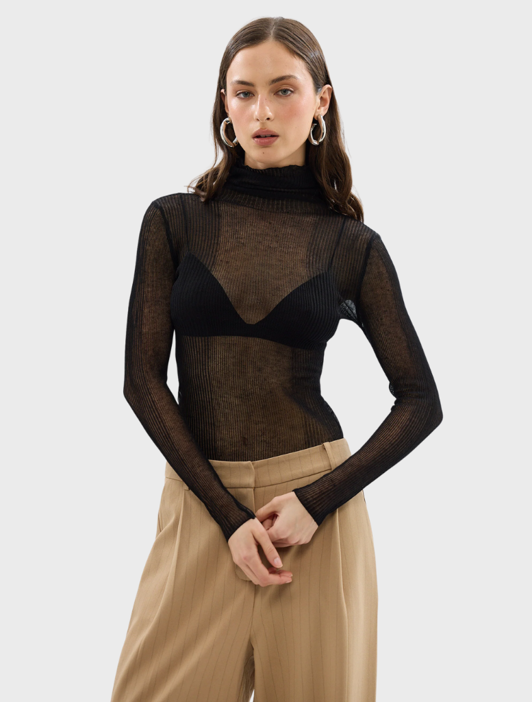 Black Riley top displayed on a hanger, showcasing its sleek design and fabric texture.