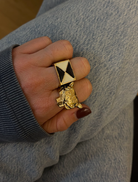 A gold plated ring showcasing an acheetah head, merging sophistication with a touch of feline whimsy.